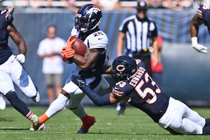Oct 1, 2023; Chicago, Illinois, USA; Chicago Bears linebacker T.J. Edwards (53) brings down Denver Broncos running back Samaje Perine (25) in the second quarter at Soldier Field. Mandatory Credit: Jamie Sabau-USA TODAY Sports